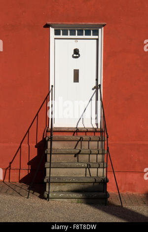 Detail der eine weiße Tür auf rot-Orange lackiert Hütte in Lavenham Suffolk England Stockfoto