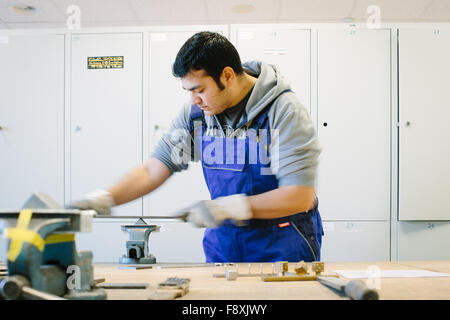 Dresden, Deutschland. 10. Dezember 2015. Afghanischer Flüchtling Sha Kah Ahmadi Dateien Metallteile an der Fortbildungsakademie der Wirtschaft-Ausbildung-Akademie in Dresden, Deutschland, 10. Dezember 2015. Die Akademie hat derzeit zwei Flüchtlinge auf Arbeit versuche, ihre Fähigkeiten einzuschätzen. Foto: OLIVER KILLIG/DPA/Alamy Live-Nachrichten Stockfoto