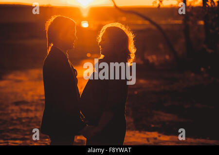 Schwangere paar auf Suset im Herbst park Stockfoto