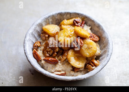 Porridge mit karamellisierten Bananen und Nüssen Stockfoto