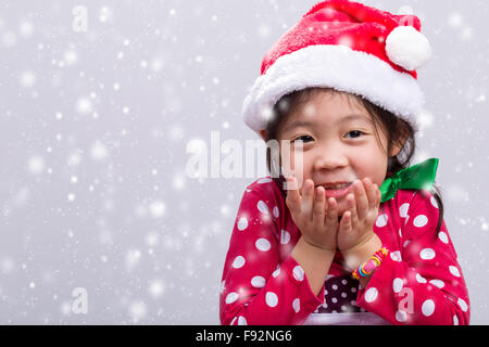 Süße asiatische Kind in Xmas roten Kostüm. Stockfoto