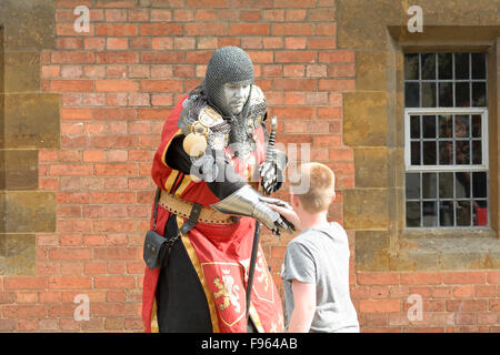 Ritter Straßenkünstler posiert mit großen Schwert und Kind in Stratford-upon-Avon, Warwickshire, England Stockfoto