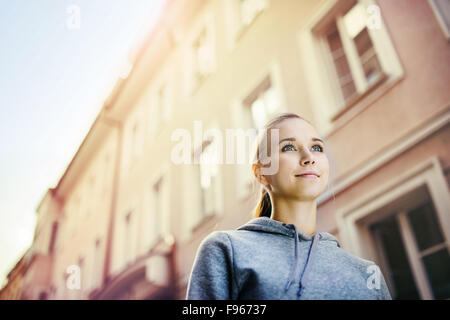 Junge weibliche Läufer ist auf gefliesten Bürgersteig im alten Stadtzentrum Joggen. Gesunde Lebensweise. Stockfoto