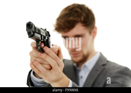 Hübscher junger Mann, mit dem Ziel, der Waffe zu einem unsichtbaren Ziel mit selektiven Fokus Stockfoto