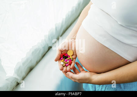 Porträt von unkenntlich schwanger Holding Pillen in ihren Händen Stockfoto