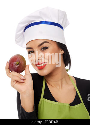 Junger Koch Dame mit einer Mango-Frucht Stockfoto