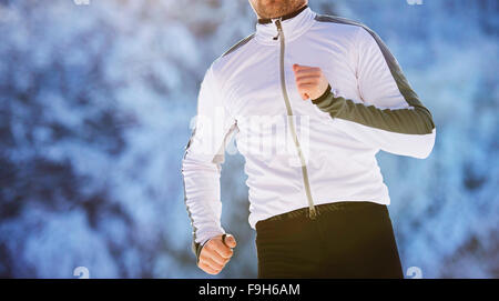 Hübscher Junge Läufer in der verschneiten Natur Stockfoto