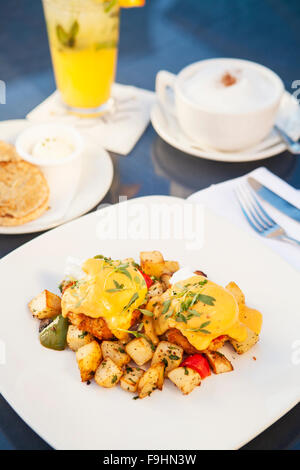 Spiegeleiern und Dungeness Krabbenkuchen Frühstück Kartoffeln, Chipotle Sauce Hollandaise, Avocado und Pico de gallo Stockfoto