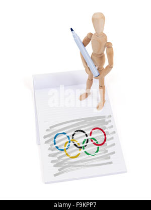 Hölzerne Puppe gemacht eine Zeichnung einer Flagge - Olympische Ringe Stockfoto