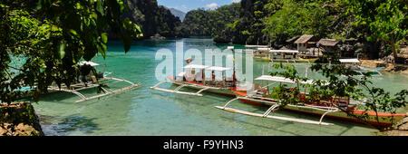 Traditionelle philippinische Holzboote in einer blauen Lagune im tropical island Stockfoto