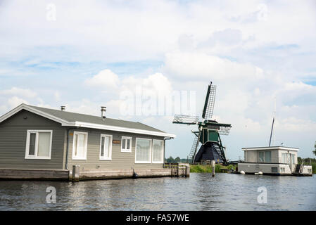 hölzerne Windmühle und Hausboot am Reeuwijkse Plassen in den Niederlanden Stockfoto