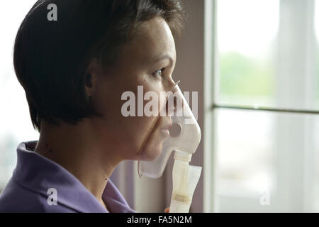 Junge Frau, die Inhalation zu tun Stockfoto