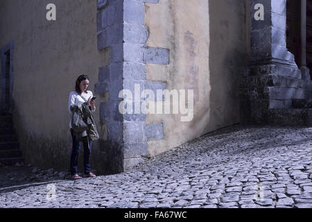 Frau stehend in Straße von SMS-Nachrichten, Lissabon, Portugal Stockfoto