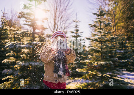 Junge Bürsten Schnee seine Handschuhe Stockfoto