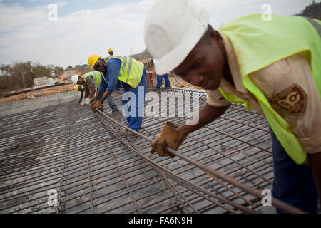 Bauarbeiter sanieren eine alternde Brücke entlang der Namialo Rio Lurio Road im Norden Mosambiks, SE Afrika. Stockfoto