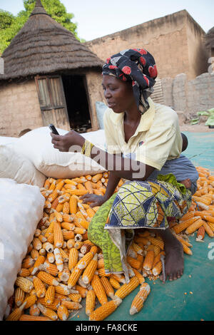 Ein Landwirt nutzt Handy-Technologie zum Preisvergleich auf verschiedenen Märkten in Banfora Abteilung in Burkina Faso, Westafrika. Stockfoto