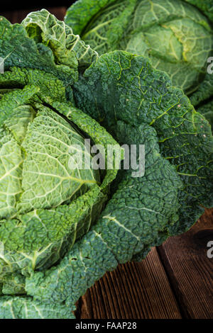 Portion frische Savoy (Nahaufnahme) auf hölzernen Hintergrund Stockfoto