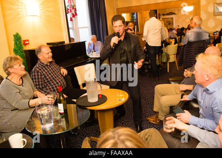 Aberystwyth Wales UK, Weihnachtstag 25. Dezember 2015 nicht jeder Zeit am Weihnachtstag hat, ab. Entertainer JAMIE YATES arbeitet an Weihnachten Abend singen für die Bewohner des Marine Hotel in Aberystwyth nach ihrer Xmas Dinner.   Bildnachweis: Keith Morris / Alamy Live News Stockfoto