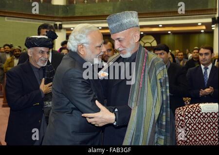 Kabul, Afghanistan. 25. Dezember 2015. Der indische Premierminister Narendra Modi wird von ehemaligen afghanischen Präsidenten Hamid Karzai begrüßt, wie Präsident Ashraf Ghani während der Einweihungsfeier des neuen afghanischen Parlaments 25. Dezember 2015 in Kabul, Afghanistan blickt auf. Modi in Afghanistan auf dem Heimweg von einem Besuch in Moskau gestoppt. Stockfoto