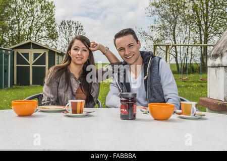 Ein paar ist auf der Terrasse sitzen und frühstücken Stockfoto