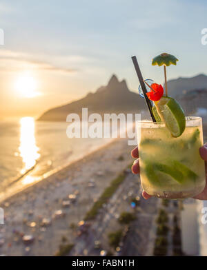 Eine köstliche Kiwi Caipirinha Drink mit Blick auf den berühmten Strand von Ipanema in Rio De Janeiro, Brasilien Stockfoto