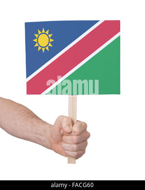 Hand, die kleine Karte, isoliert auf weiss - Flagge von Namibia Stockfoto