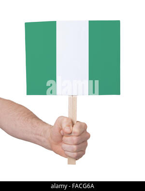 Hand, die kleine Karte, isoliert auf weiss - Fahne von Nigeria Stockfoto