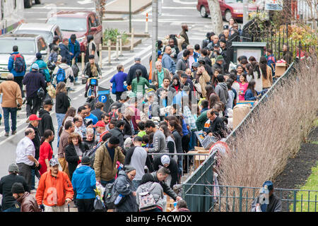 Freiwillige verteilen warmes Wetter Kleidung, Decken und andere Requisiten für die Obdachlosen und Armen vor der Kirche der Heiligen Apostel in Chelsea in New York am Heiligabend, 24. Dezember 2015.  (© Richard B. Levine) Stockfoto