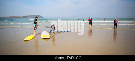 Surfer am Polzeath Strand in Cornwall, England, Vereinigtes Königreich Stockfoto