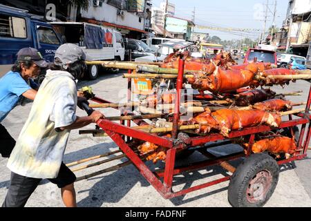 Arbeiter der Laloma in Quezon City (die Lechon Hauptstadt der Philippinen) bereitet die Lechon Baboy (gebratenes Schweinefleisch), die für die kommende Feier der Noche Buena oder Silvester Feier zur Abholung bereitstehen, nach der Lechonero (gebratenes Schweinefleisch kochen) kochen sie gebratene Schweinefleisch von 2 bis 3 Stunden, es hängt immer noch über die Größen und sie kochen es in traditionelle Weise oder manuelle Drehung des Schweinefleisches. Die Preise der Lechon Baboy (gebratenes Schweinefleisch) beginnen bei 4,00 Pesos bis zu 15.000 pro. (Foto von Gregorio B. Dantes Jr. / Pacific Press) Stockfoto