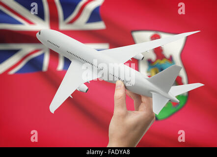 Flugzeug in der Hand mit Nationalflagge auf Hintergrund - Bermuda Stockfoto