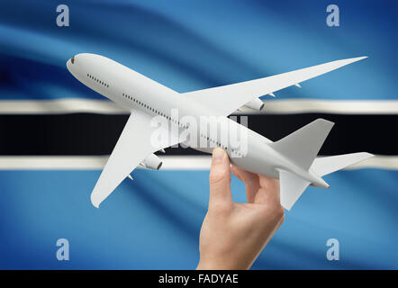 Flugzeug in der Hand mit Nationalflagge auf Hintergrund - Botswana Stockfoto