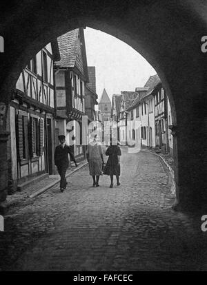 Menschen Unter Einem Stadttorbogen in Einer Kleinstadt in der Eifel, Deutschland 1920er Jahre. Die Leute an einem Torbogen von einem alten Stadttor in eine Stadt in der Eifel, Deutschland der 1920er Jahre. Stockfoto