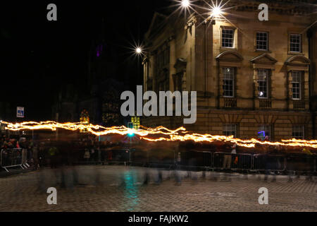 Edinburgh, Schottland. 30. Dezember 2015. Eine Band der Flamme Schlangen seinen Weg über die Royal Mile wie Tausende von Menschen marschieren mit Fackeln zu Beginn der Hogmanay, Schottlands Tradition der Abschied vom alten Jahr zu feiern. Brian Wilson/Alamy Live-Nachrichten. Stockfoto