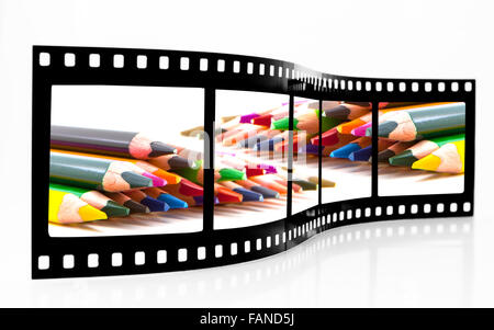 Filmstreifen mit farbigen Buntstifte auf weißem Hintergrund Stockfoto