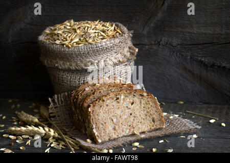 Brot und Getreide in der Tasche auf einem Vintage Holzbrettern Stockfoto