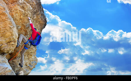 Kletterer mit Rucksack Klettern auf einer Klippe Stockfoto