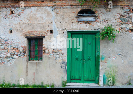 Alte italienische Steinhaus vorne mit grünen Tür Stockfoto