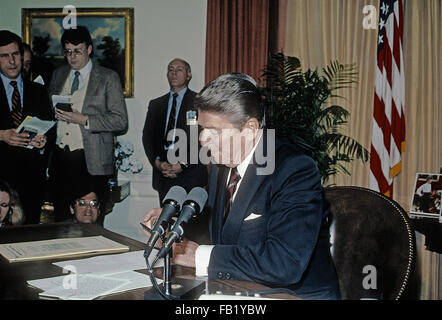 Washington, DC, USA, 6. März 1985 Präsident Ronald Reagan sitzt an seinem Schreibtisch im Oval Office des weißen Hauses, Unterzeichnung der Veto-Nachricht für die Farm Credit und afrikanische Hunger Relief Bill Credit: Mark Reinstein Stockfoto