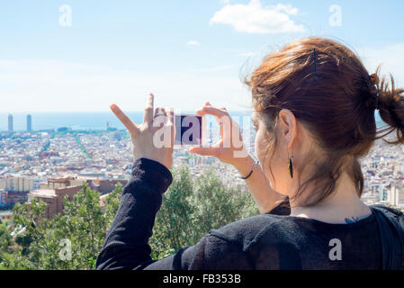 Ein Mädchen, das mit ihrem Telefon Fotos von Barcelona von der Spitze des Arena Shopping Centers in Placa de Espana machte Stockfoto