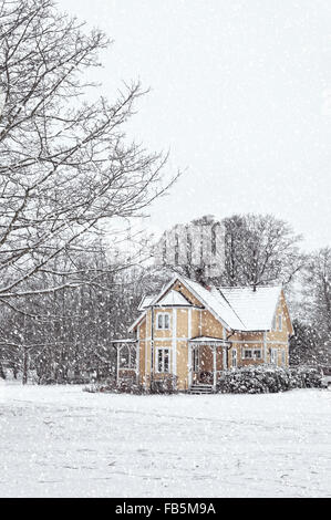 Eine schneebedeckte Haus befindet sich am Ramlosa Brunnspark am Stadtrand von Helsingborg in Schweden. Stockfoto