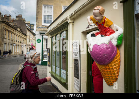 Ein Mittelalter-Weibchen zu Fuß in Richtung David Thayer Ice Cream Shop, Bath, Somerset, Großbritannien Stockfoto