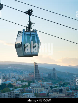 Moderne Seilbahn Kabine über die Stadt Tbilisi in der Abenddämmerung. Georgien Stockfoto