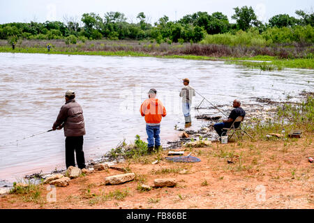 Menschen Fisch in den Fluten des Sees Hefner in Oklahoma City nach einem Frühlingsregen. Oklahoma, USA. Stockfoto