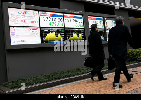 Tokio, Japan. 12. Januar 2016. Fußgänger gehen vorbei an einem Lager Elektronikplatine zeigt Japans Nikkei Stock Average, die 2,7 Prozent auf 17,218.96 auf 12. Januar 2016, Tokyo, Japan fiel. Die japanischen Aktien fiel am Dienstag stürzen die Rohölpreise und Premierminister Shinzo Abe Kommentare über Steuererhöhungen im Parlament. Bildnachweis: Rodrigo Reyes Marin/AFLO/Alamy Live-Nachrichten Stockfoto