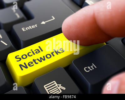 Computer-Benutzer drückt gelbe Taste soziale Netzwerke auf schwarzen Tastatur. Detailansicht. Der Hintergrund jedoch unscharf. Stockfoto