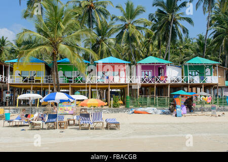 Bunte Strandhäuschen unter den Palmen am Strand von Palolem, in Goa, Indien Stockfoto