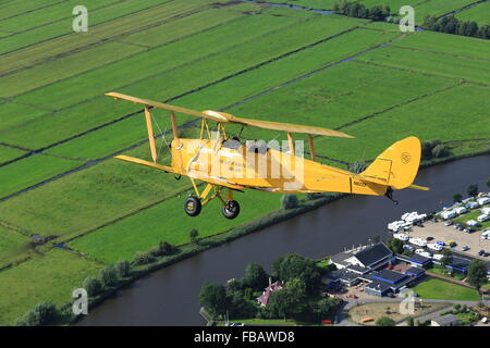 Eine de Havilland Tiger Moth Doppeldecker über die niederländische Landschaft Stockfoto