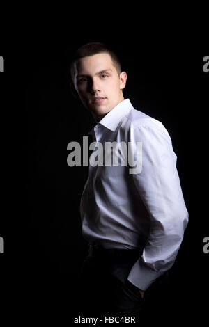 Porträt von hübscher zuversichtlich junger Mann im weißen Hemd Stockfoto