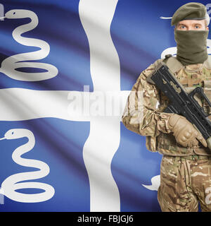 Soldat mit Maschinengewehr und Nationalflagge auf Hintergrund-Serie - Martinique Stockfoto